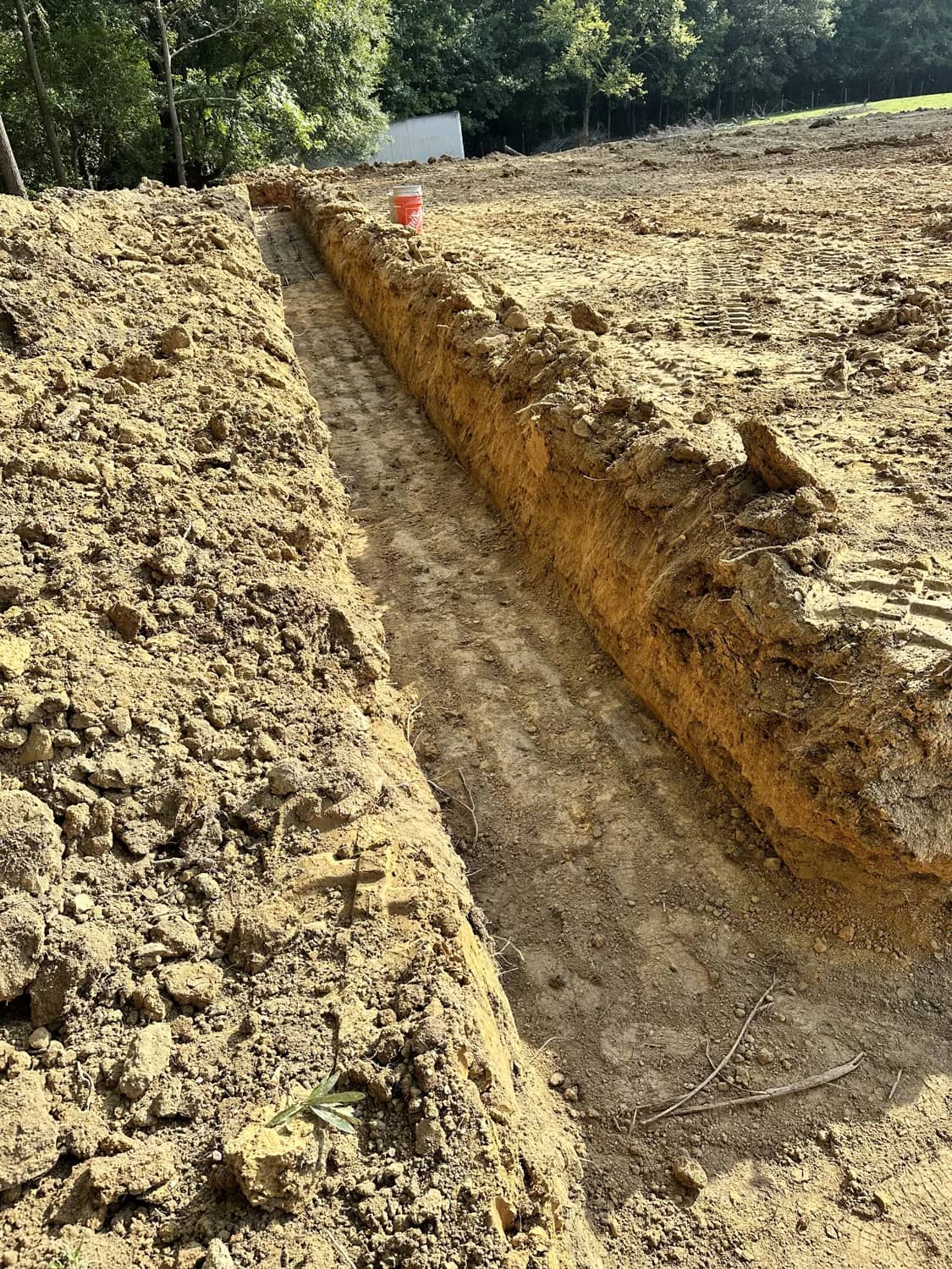 Trench excavation cut across a prepared dirt site